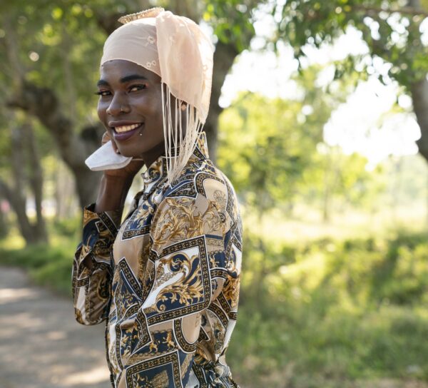 a person with a scarf wrapped around the head, looking into the camera